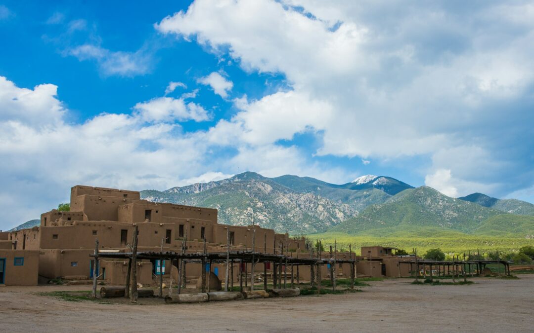 Pueblo houses in Taos, New Mexico with mountains in the background